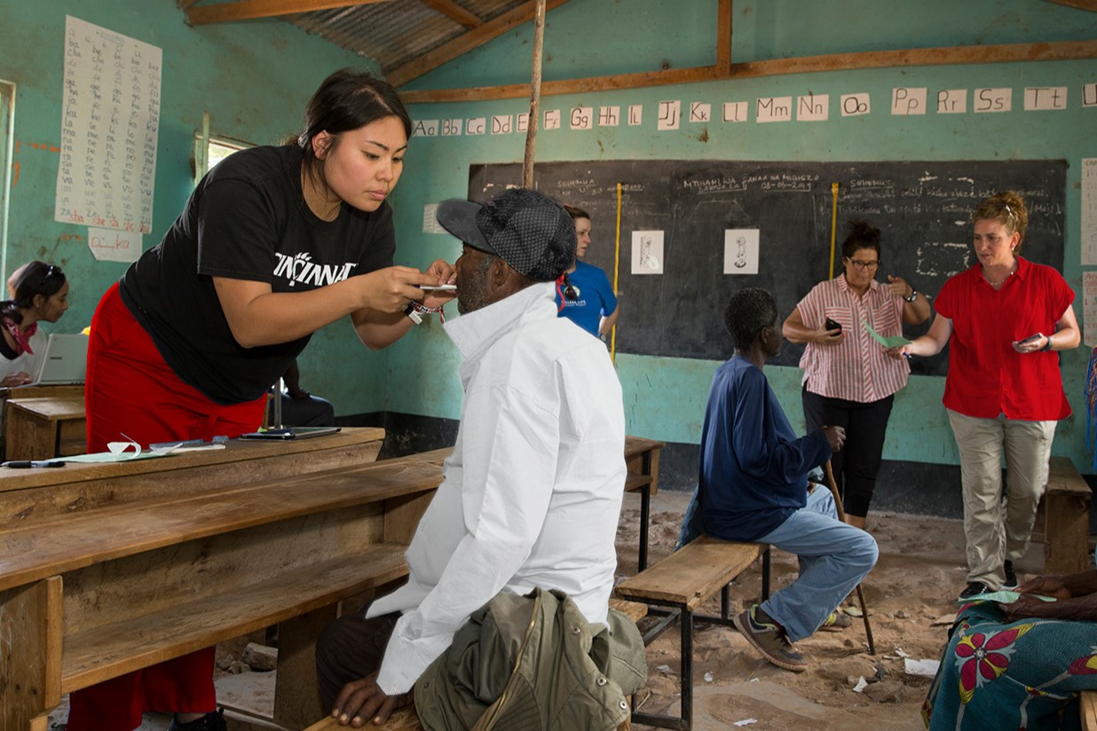 nursing student examining man in community setting
