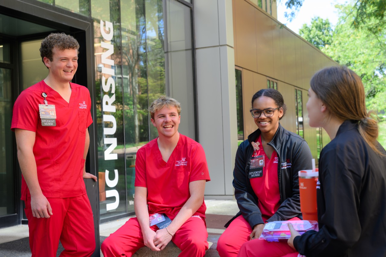 students socializing in front of procter hall
