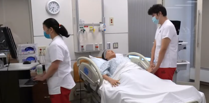 Students and manikin in simulation lab